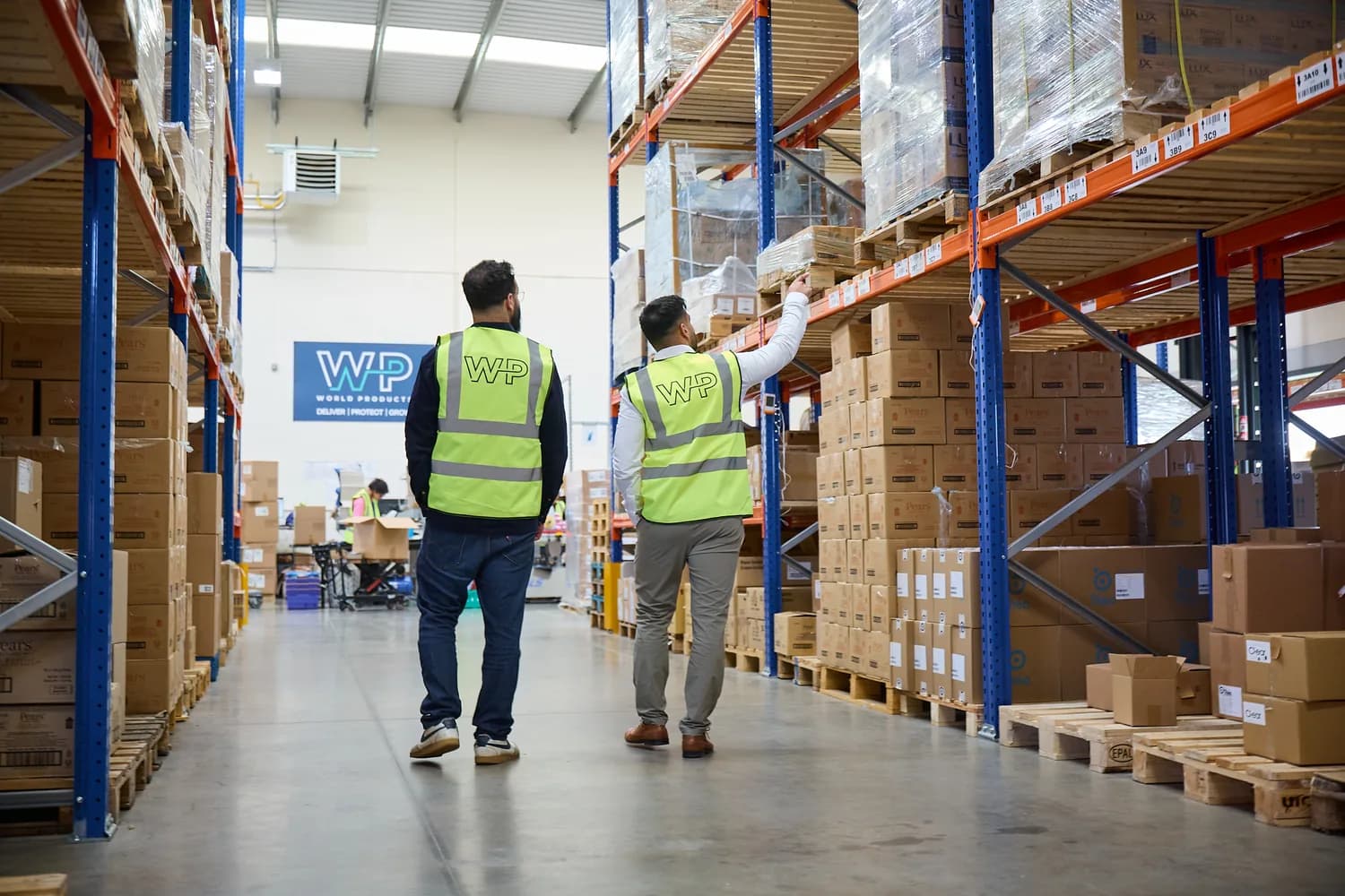 Two World Products team members walking the warehouse floor together