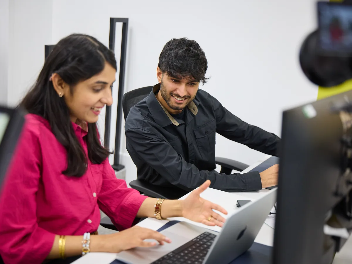 Two World Products account managers reviewing an Amazon strategy on screen