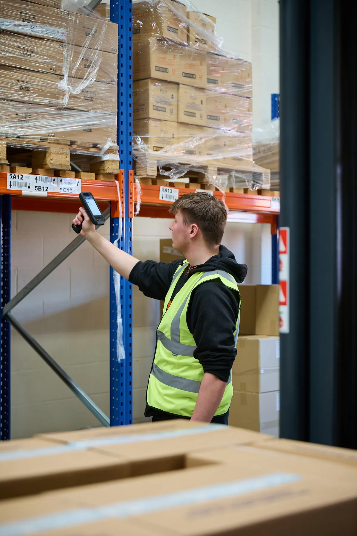 A World Products operative scanning stock in the fulfilment warehouse